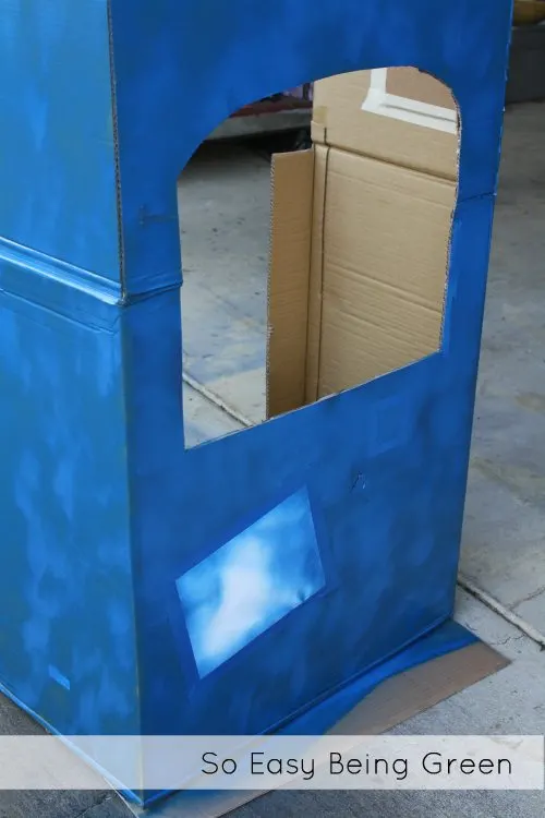 cut out of cardboard playhouse box painted blue