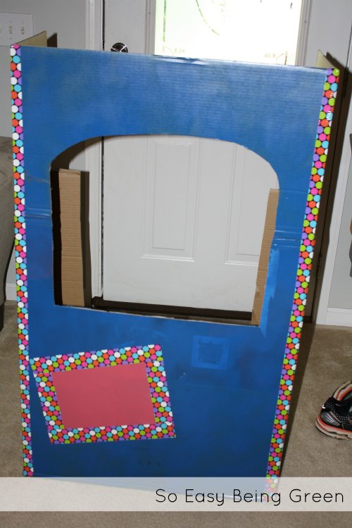 blue cardboard playhouse box with decorative duct tape