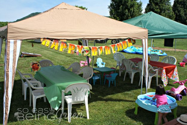 Dinosaur Birthday Party decorations outside on tent with tables