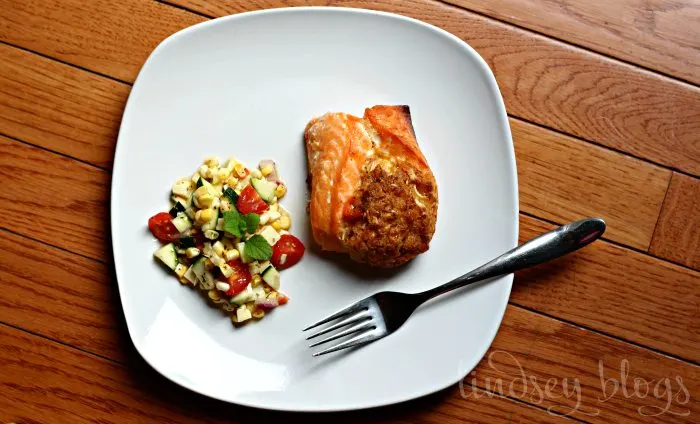 Zucchini Corn Salad with Salmon on white plate with fork