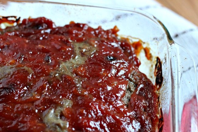 meatloaf topped with ketchup in glass dish close
