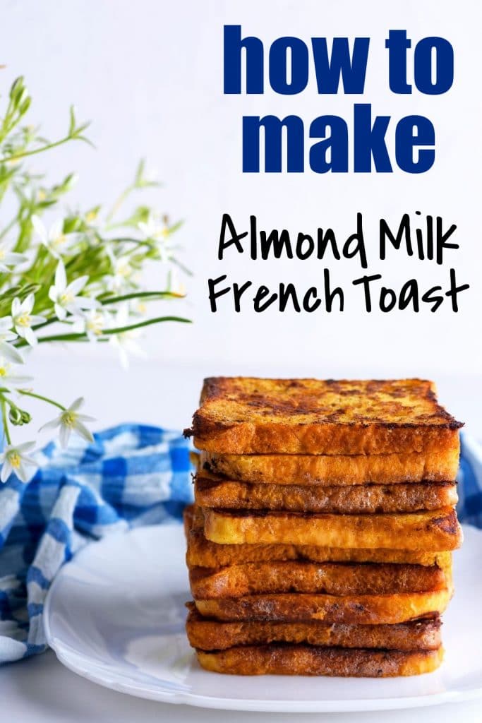 french toast stacked on white plate with blue napkin and white flowers with text almond milk french toast