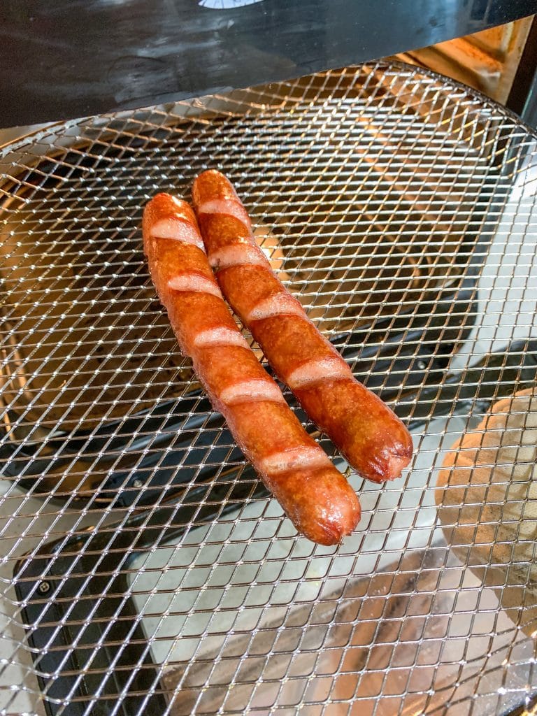 hot dogs sitting on air fryer tray