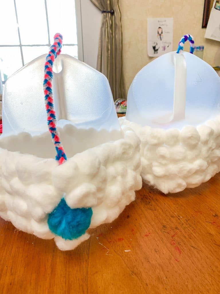 back view of milk jug easter basket with cotton balls and pom pom tail
