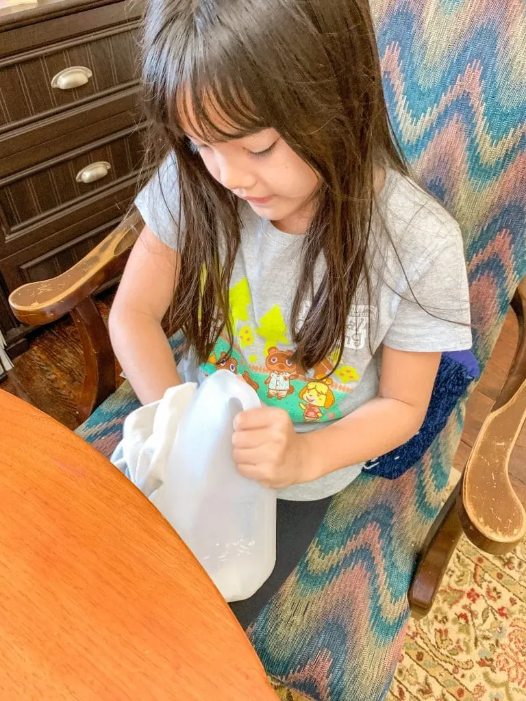 child drying inside of plastic gallon milk jug
